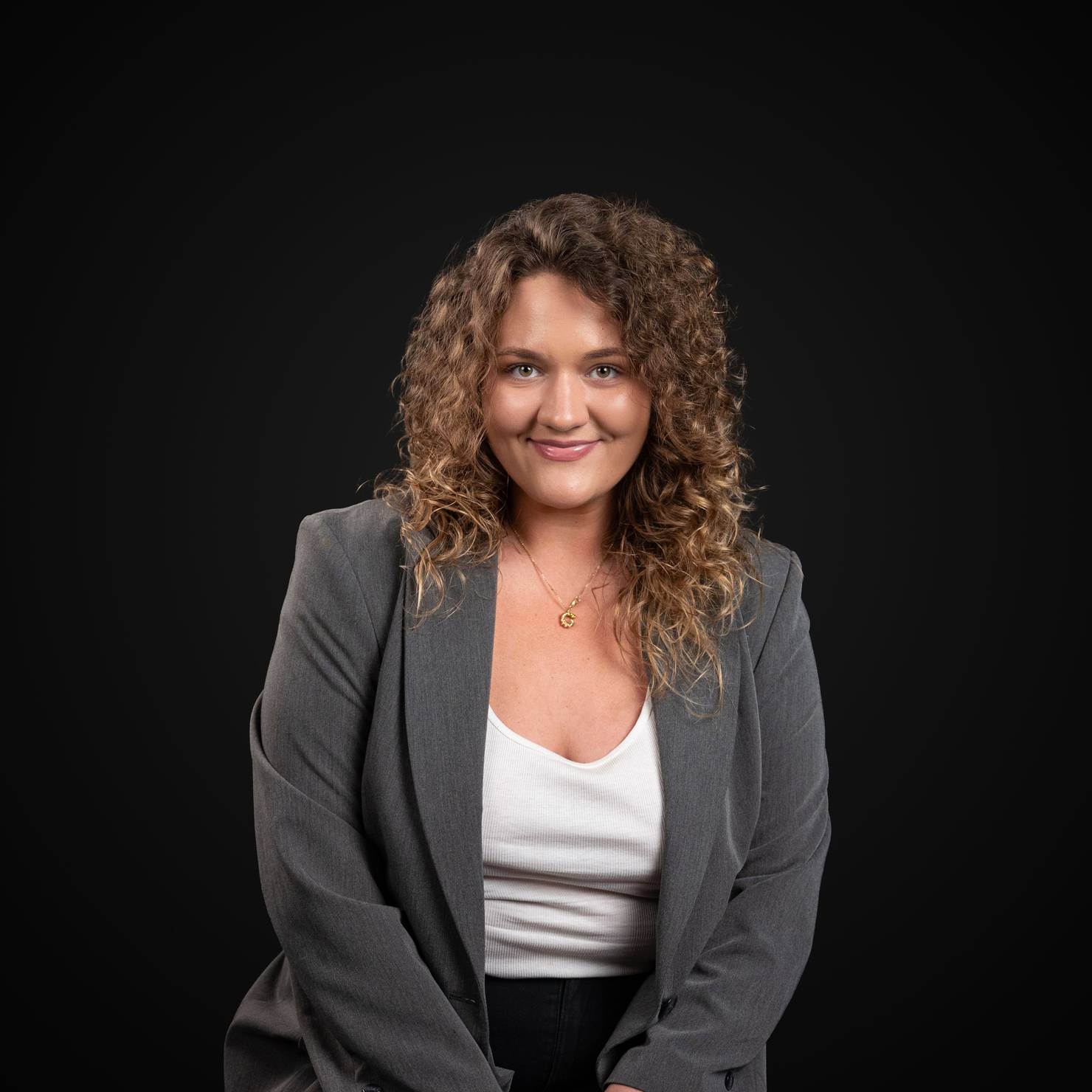 Professional photo of the Decodo's Head of Customer Experience smiling at the camera.