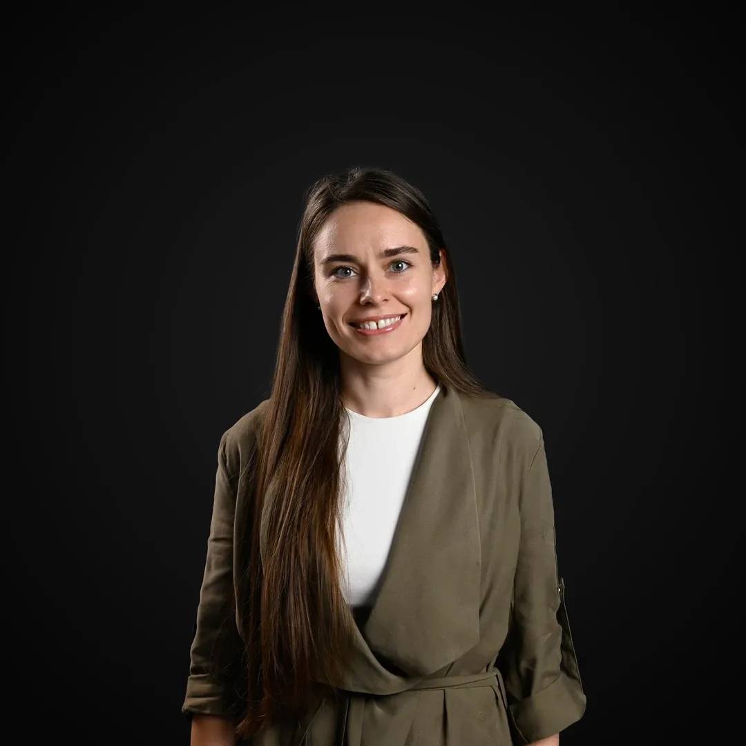 Professional photo of the Decodo's Head of Data & Analytics smiling at the camera.