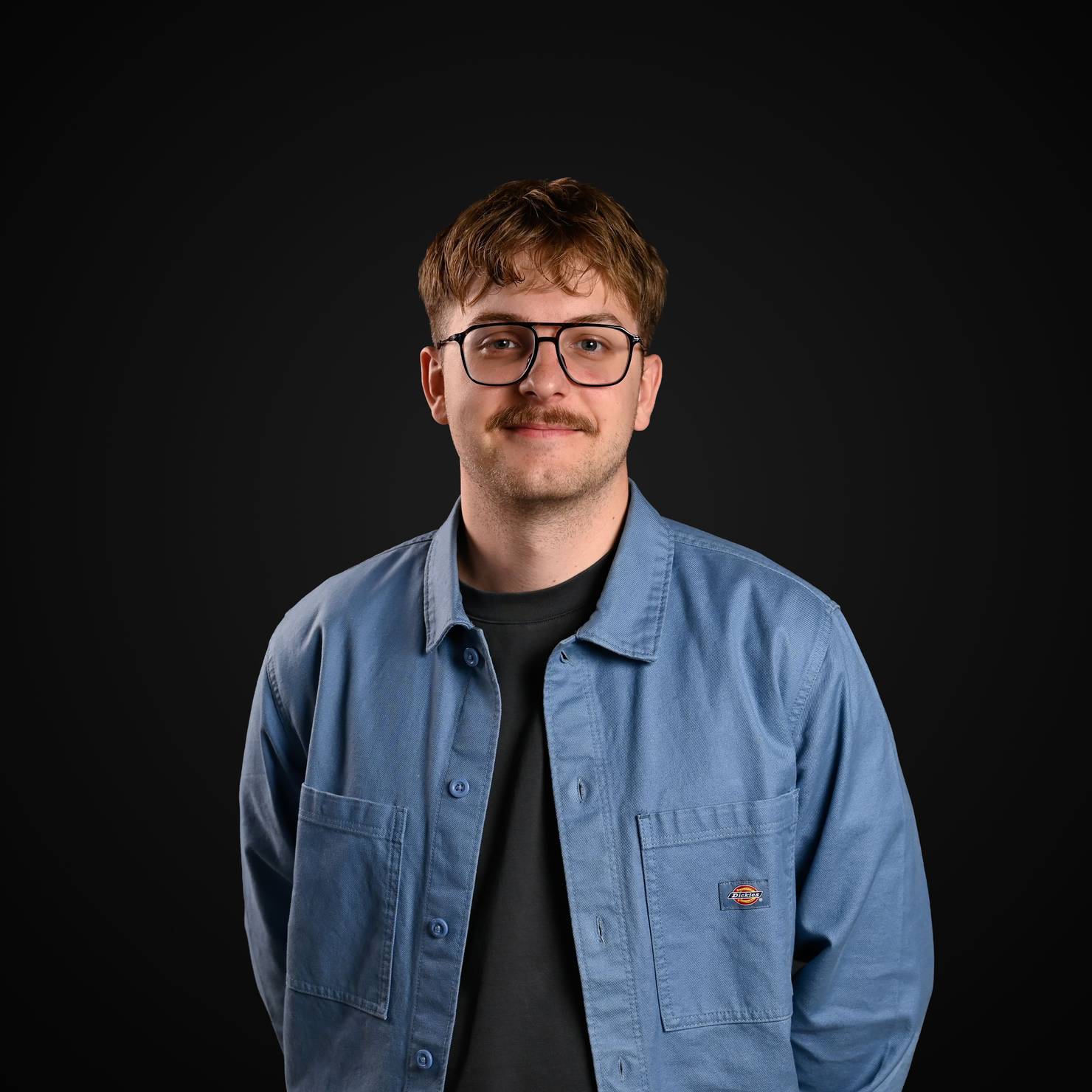 Professional photo of the Decodo's Head of Commerce smiling at the camera.